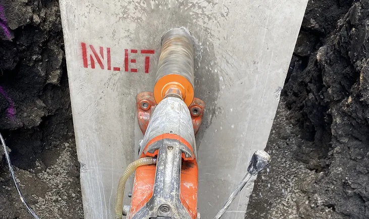 Core drilling a hole through a concrete slab