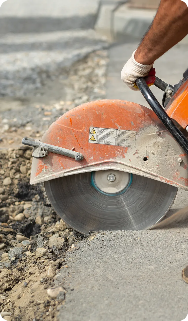 Hand saw cutting concrete in a tight access area